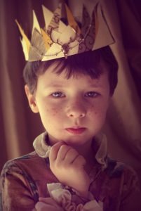 Portrait of a young boy wearing a crown