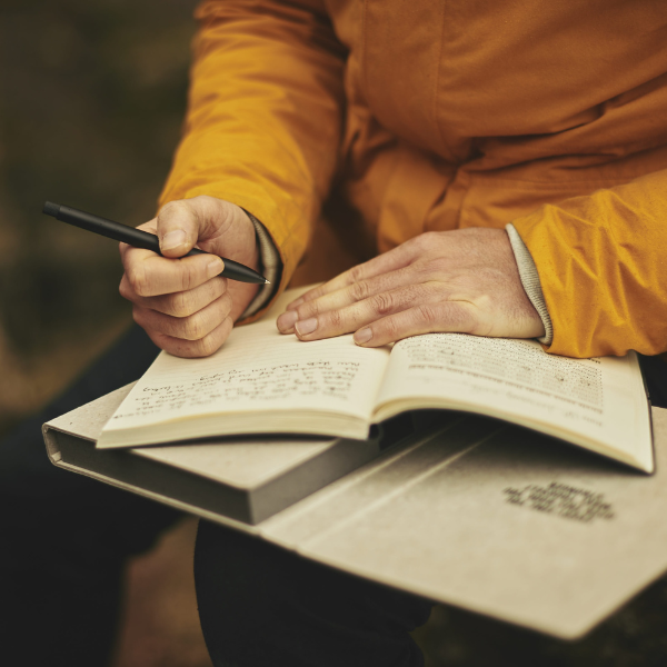 man writing in a journal. Pete and the Water Tower image