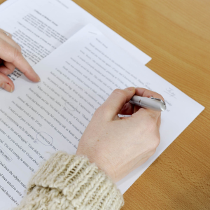 Image of person checking a paper. Copy Editing