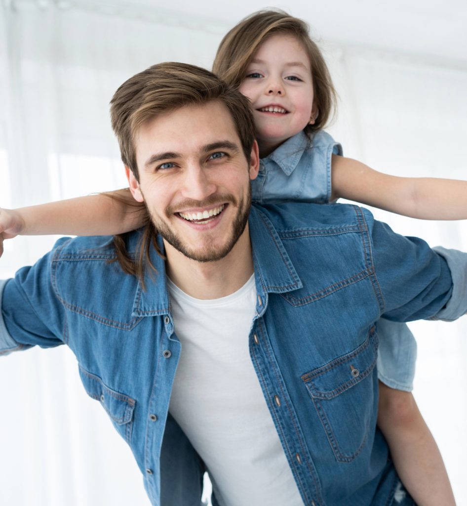 Image of a man with a little girl on his back, pretending to fly